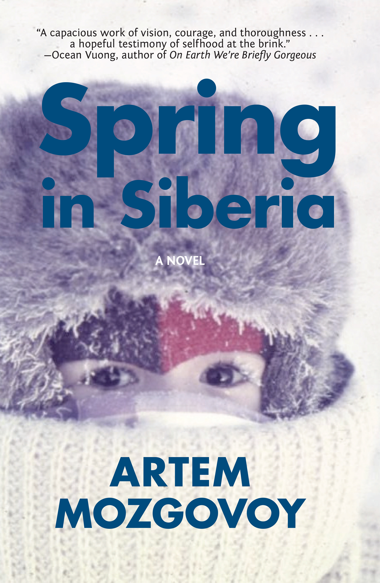 Blue text that reads in large block letters "Spring in Siberia: A Novel by Artem Mozgovoy" over an image of a young boy bundled in winter clothing with a large fur hat so only his eyes are seen, eyelashes coated in ice and snow