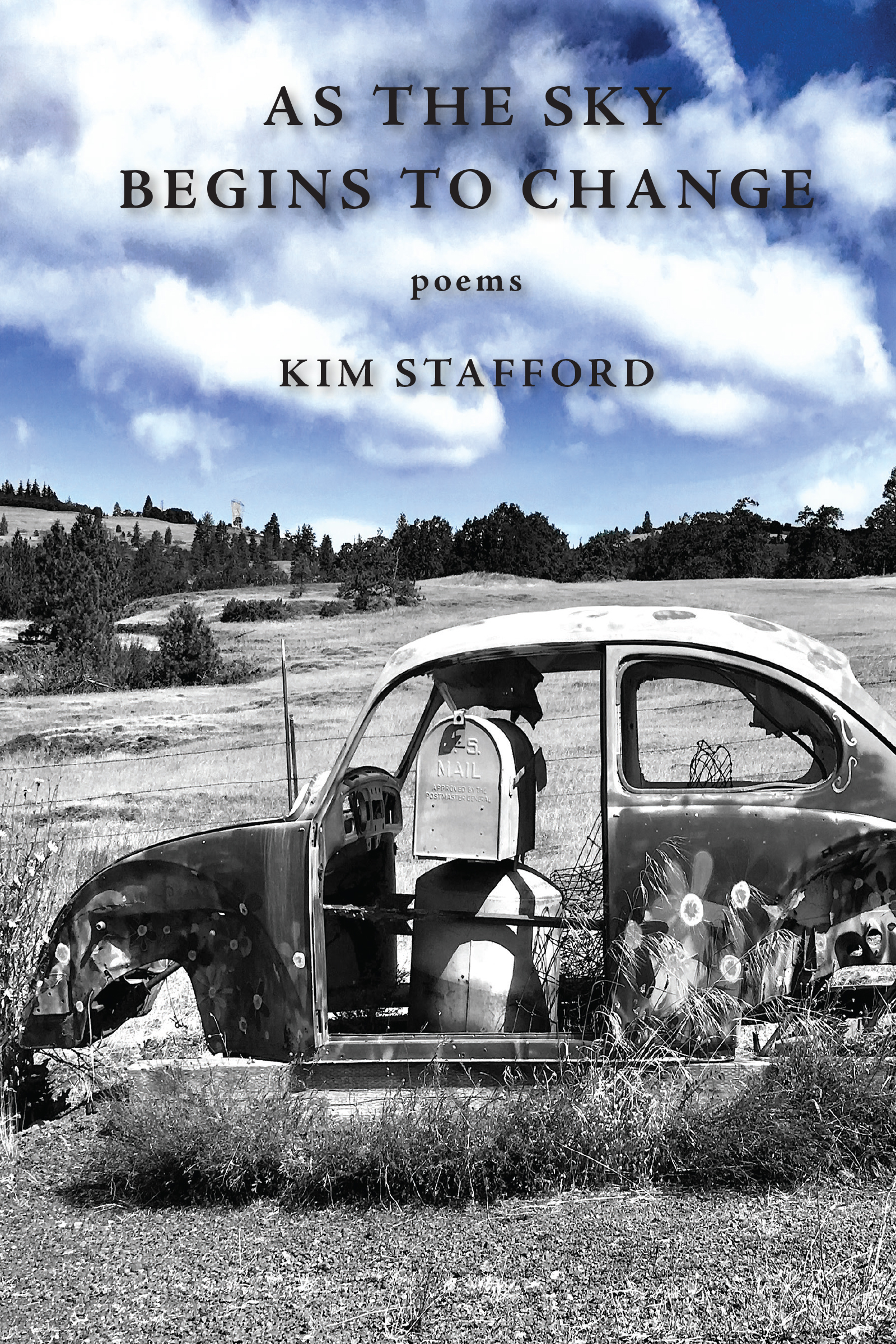 A black and white photograph of an old VW Bug car on a grassy field, with only the sky in color. Black text reads "As the Sky Begins to Change, Poems, Kim Stafford"